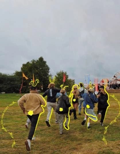 A group of friends running towards a festival across a field, outlined with yellow Bigger Picture doodles